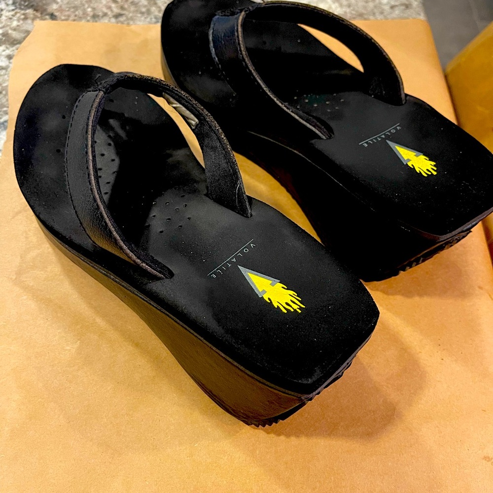 VOLATILE black platform wedge flip flops. 3” heel.